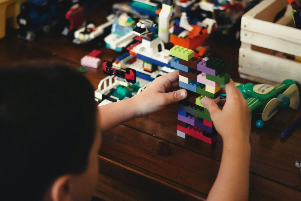 Child playing with Lego on a table
