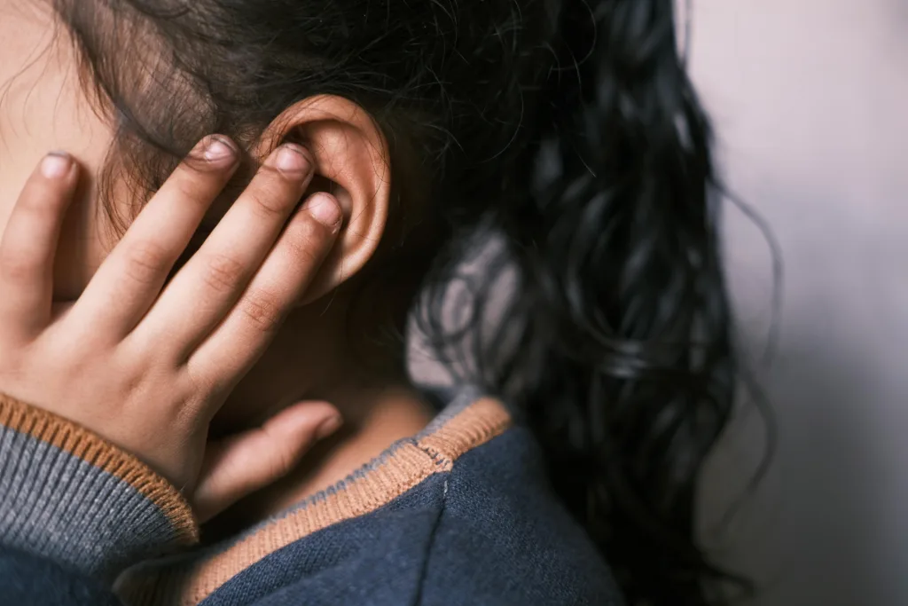 Child covering ear