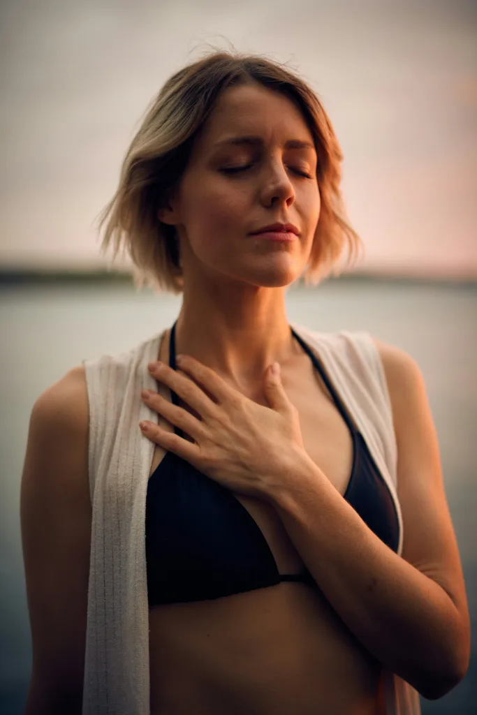 darius-bashar-xMNel_otvWs-unsplash Woman calmly breathing holding chest