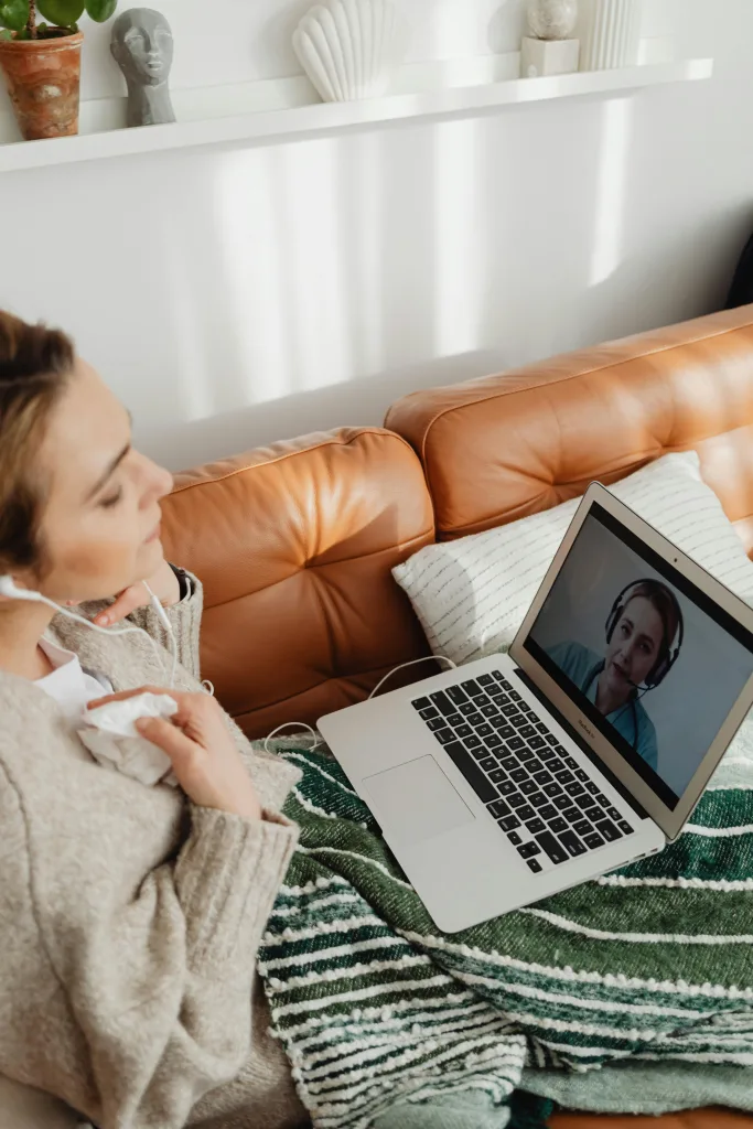 Person with talking with person on laptop
