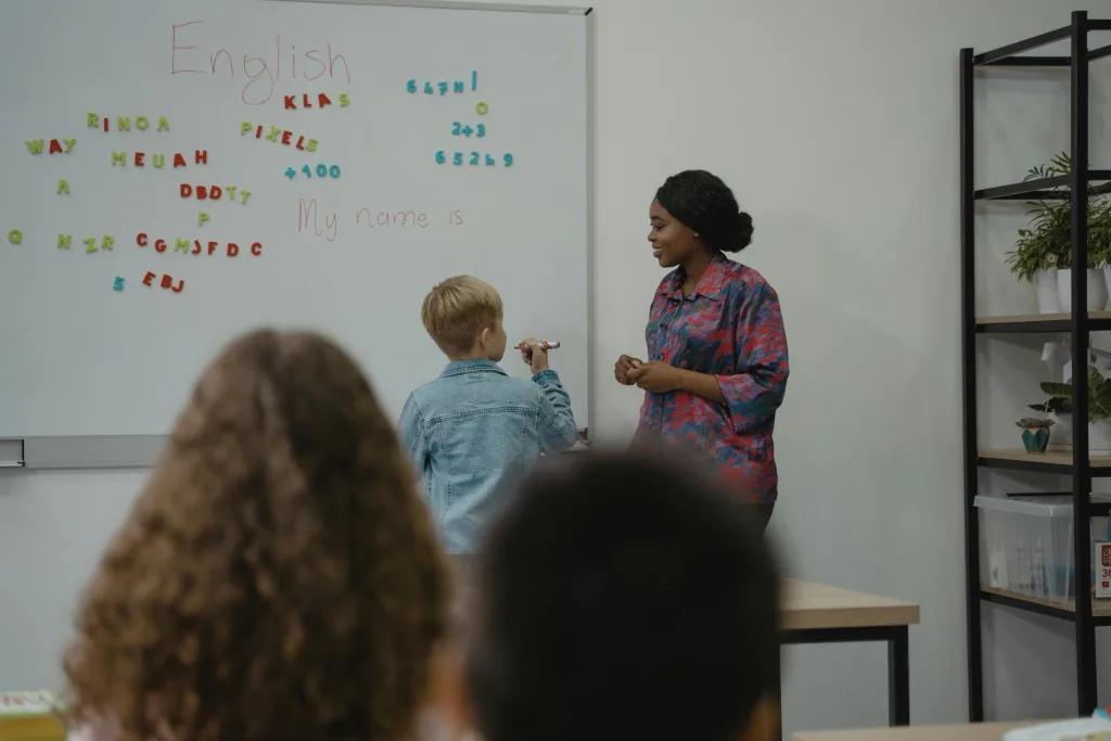 Teacher with pupil at a whiteboard