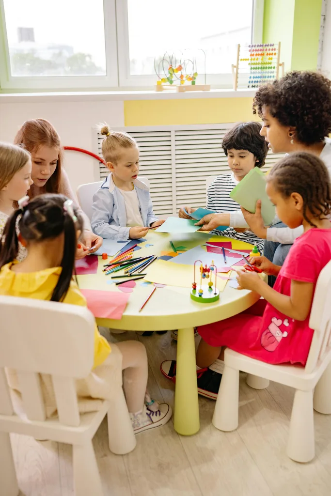 Children seated around a table playing