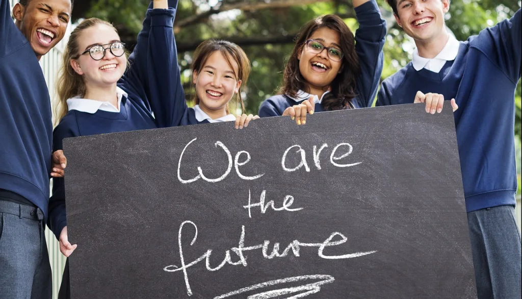 Children holding blackboard saying We are the Future